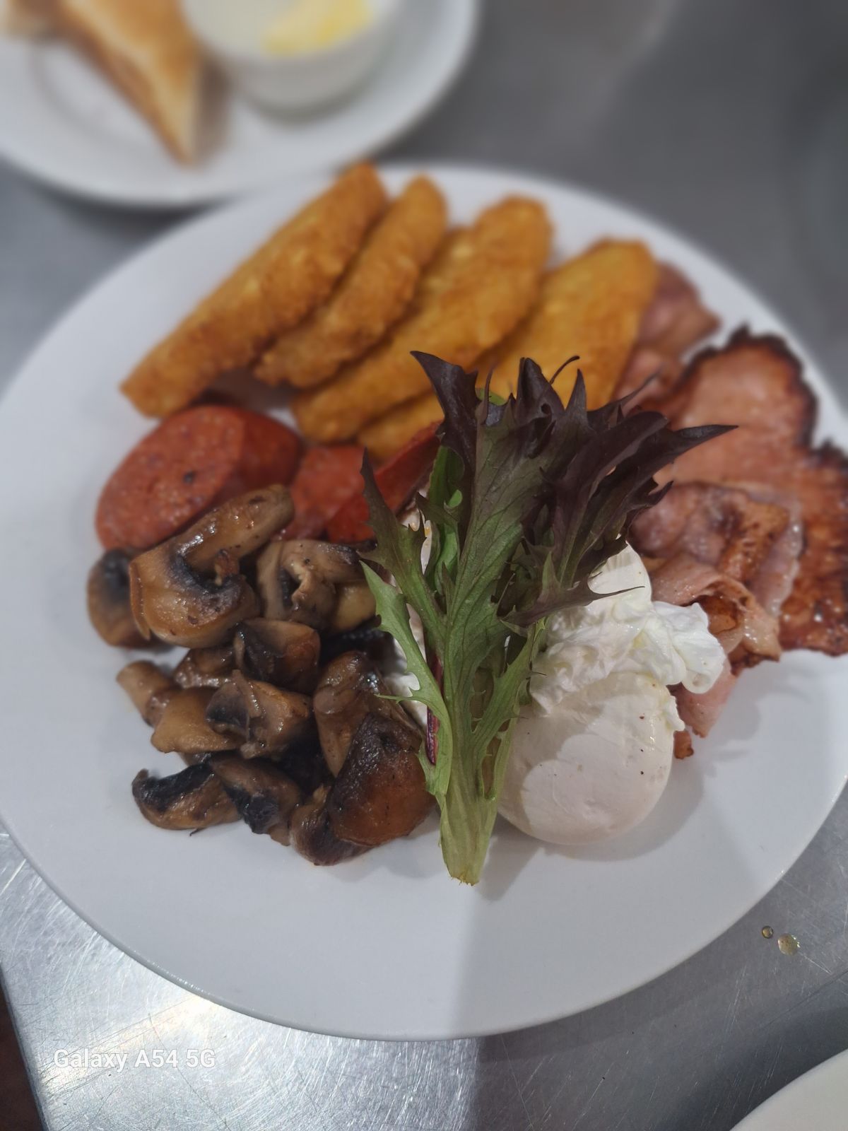 Breakfast plate with eggs, bacon, chorizo and mushrooms at Cattle Dog Cafe in Muswellbrook