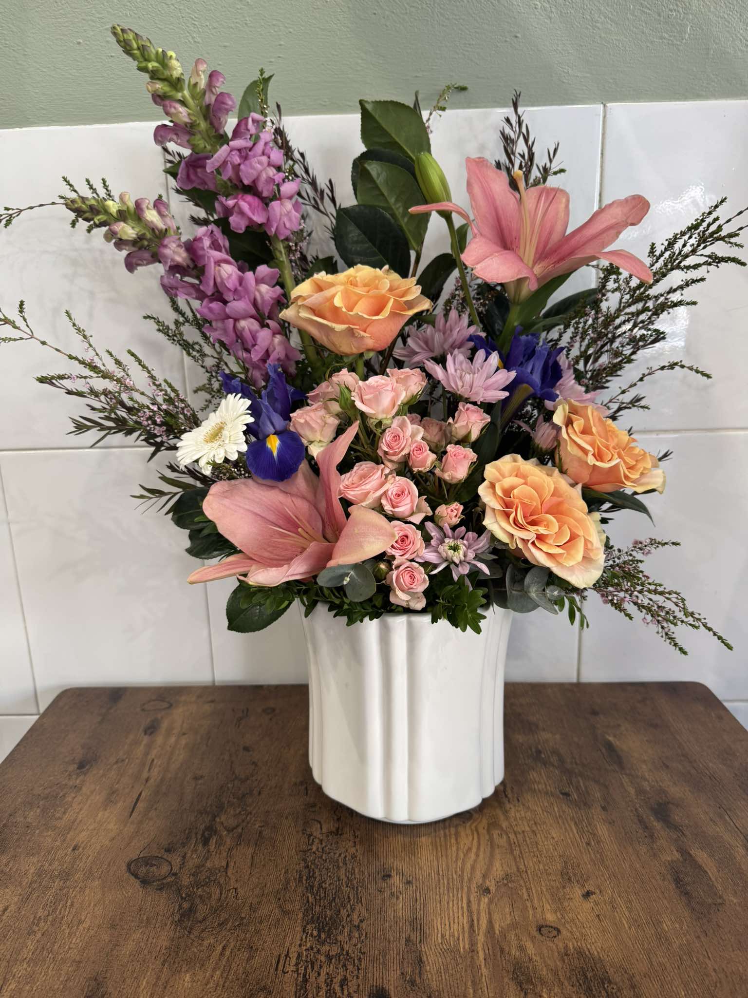 Pink and orange flower arrangement handcrafted by Cattle Dog Florist in Muswellbrook